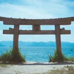 A low angle shot of a torii at a beach in Naoshima Island, Japan during summer